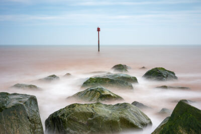 Red Marker Pole In Surreal Waters